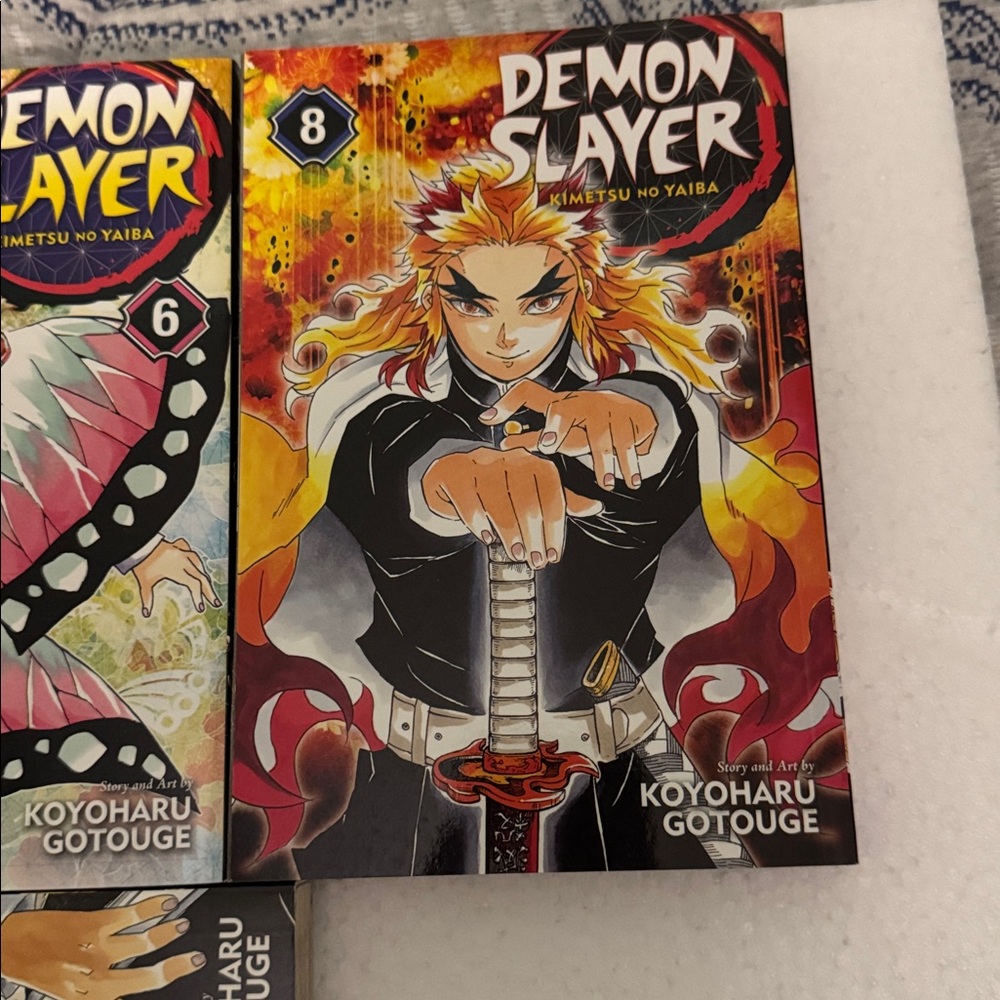 Manga Demon Slayer Volumes — Blue, Yellow, Black, Pink, Orange - Picture 4 of 5